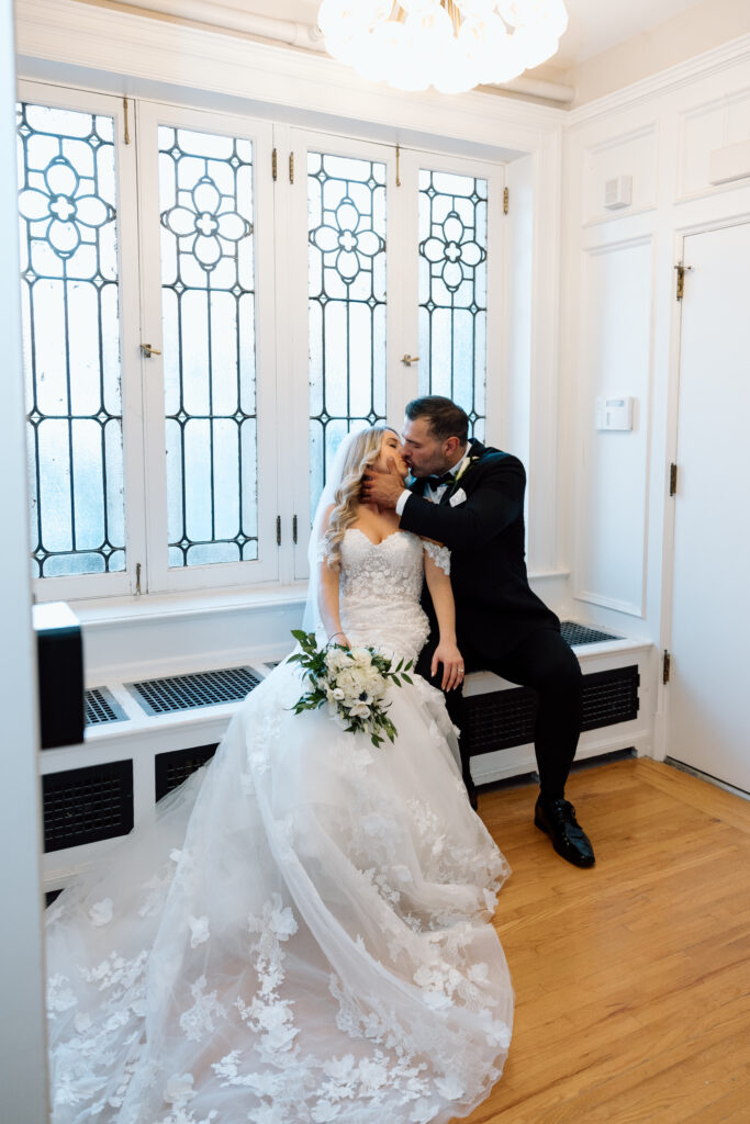 Newlyweds sitting by a window at King Mansion.