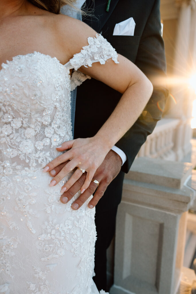 Close up of the bride and grooms wedding outfit and wedding rings.