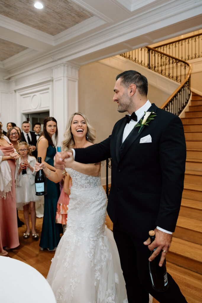 Bride and groom laughing together at their reception at King Mansion.