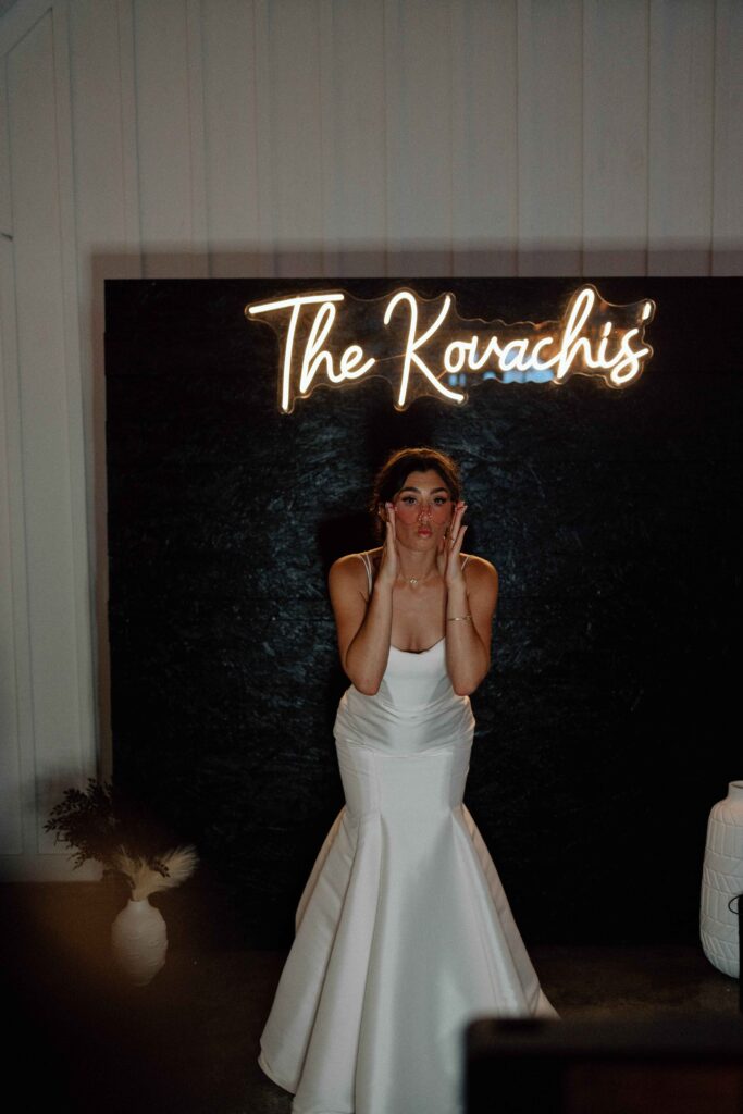 Bride posing for a photo booth at her wedding at The Lookout at Hope Lake.