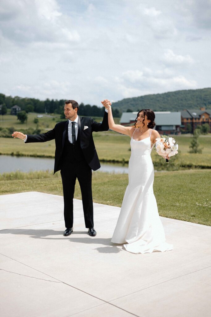 Bride and groom cheering together.