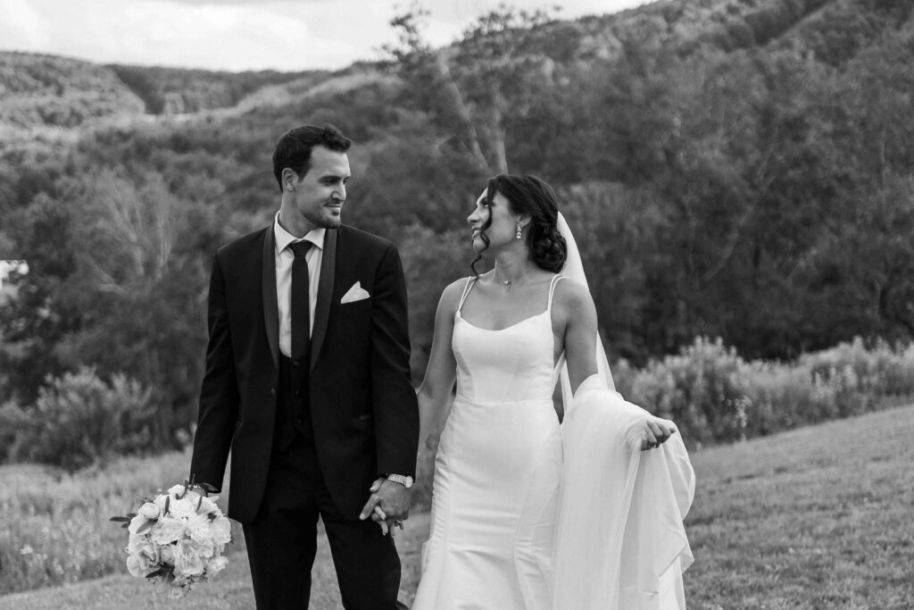 Bride and groom walking during wedding portraits at The Lookout at Hope Lake. 