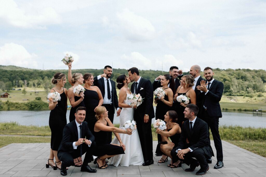 Wedding party smiling all together at the black and white wedding.