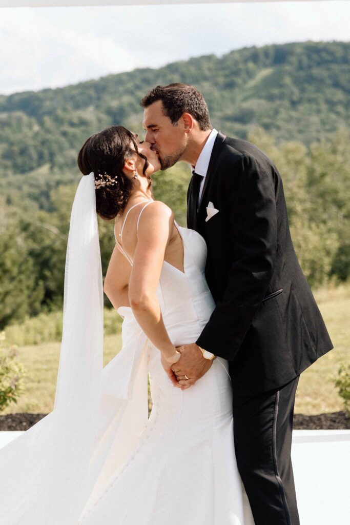 Bride and groom kissing after saying "I do" 