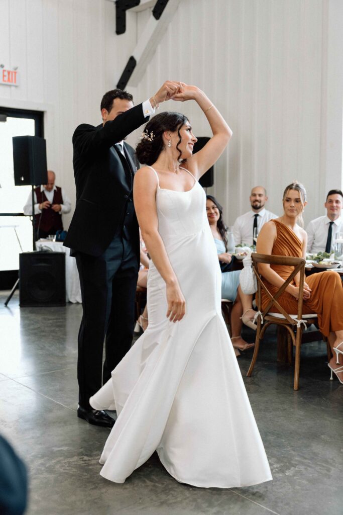 Groom spinning his bride during their first dance at The Lookout at Hope Lake.