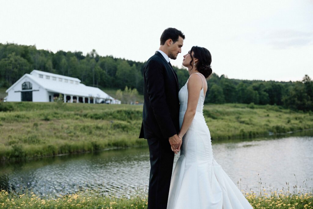 Bride and groom holding hands and looking into each others eyes at The Lookout at Hope Lake.