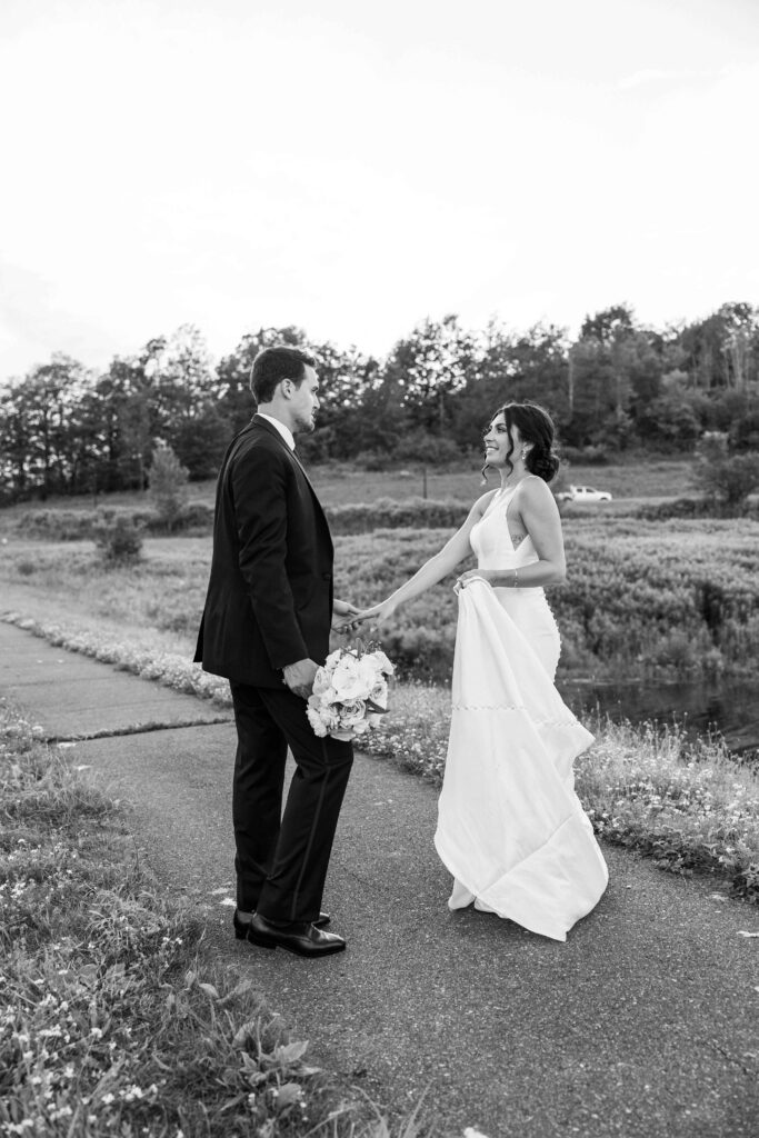 Bride and groom talking in between taking photos at The Lookout at Hope Lake.