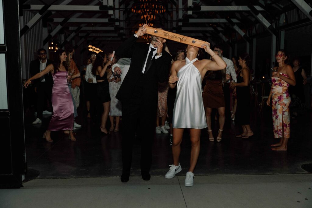 Bride and groom taking a shot before leaving their black and white wedding reception.