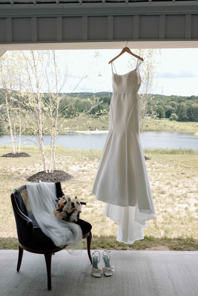 Wedding gown handing outside the venue at The Lookout at Hope Lake.