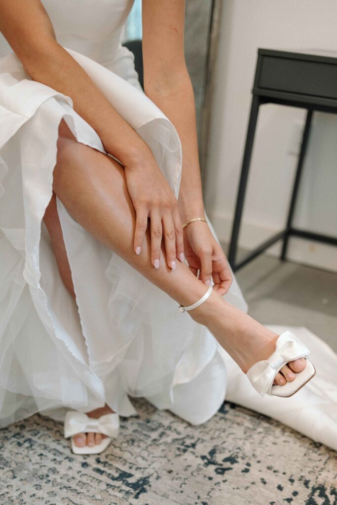 Bride putting on her wedding heels.