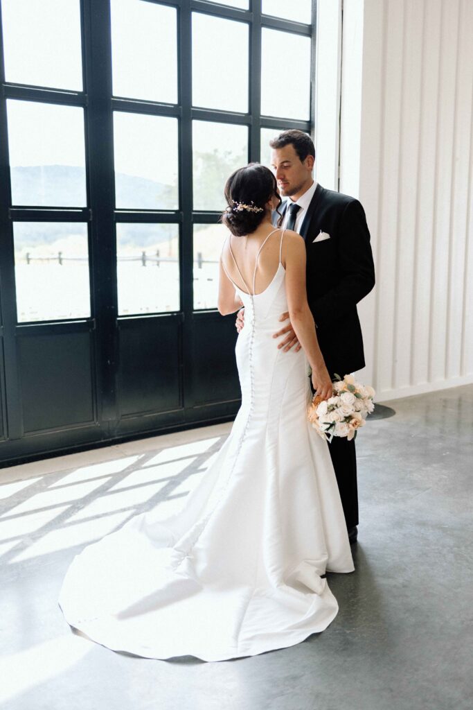 Bride and groom looking into each others eyes at their black and white wedding.