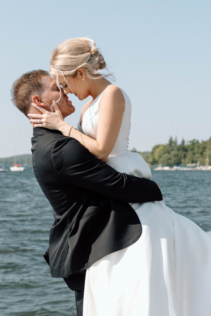 Newlyweds about to kiss on a dock in New York.