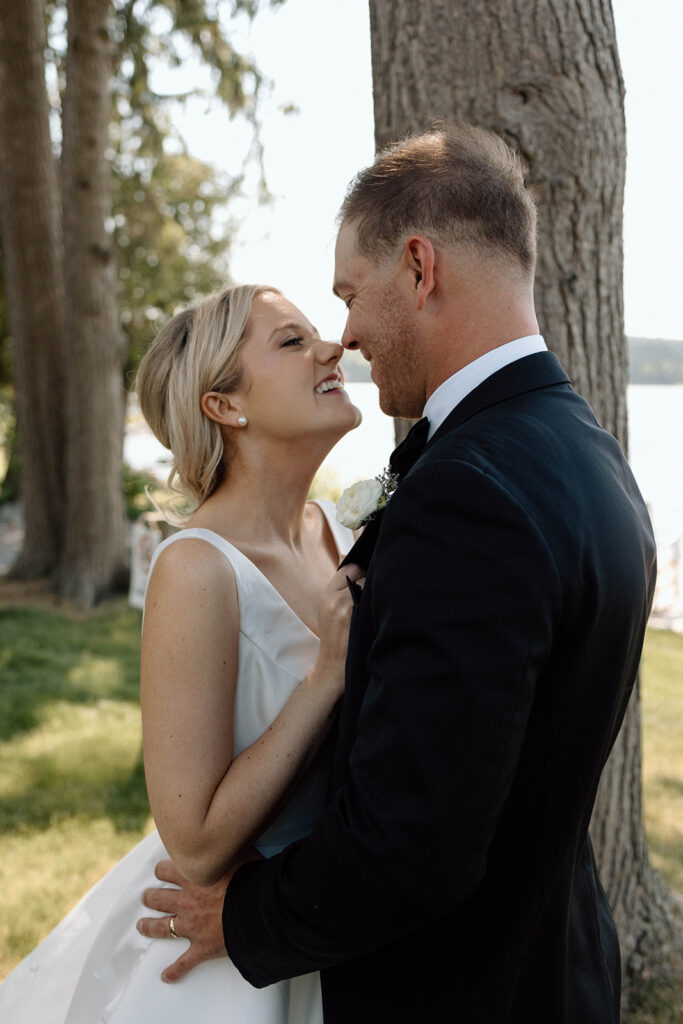 Bride and groom smiling together during their wedding portraits following their wedding photography timeline.