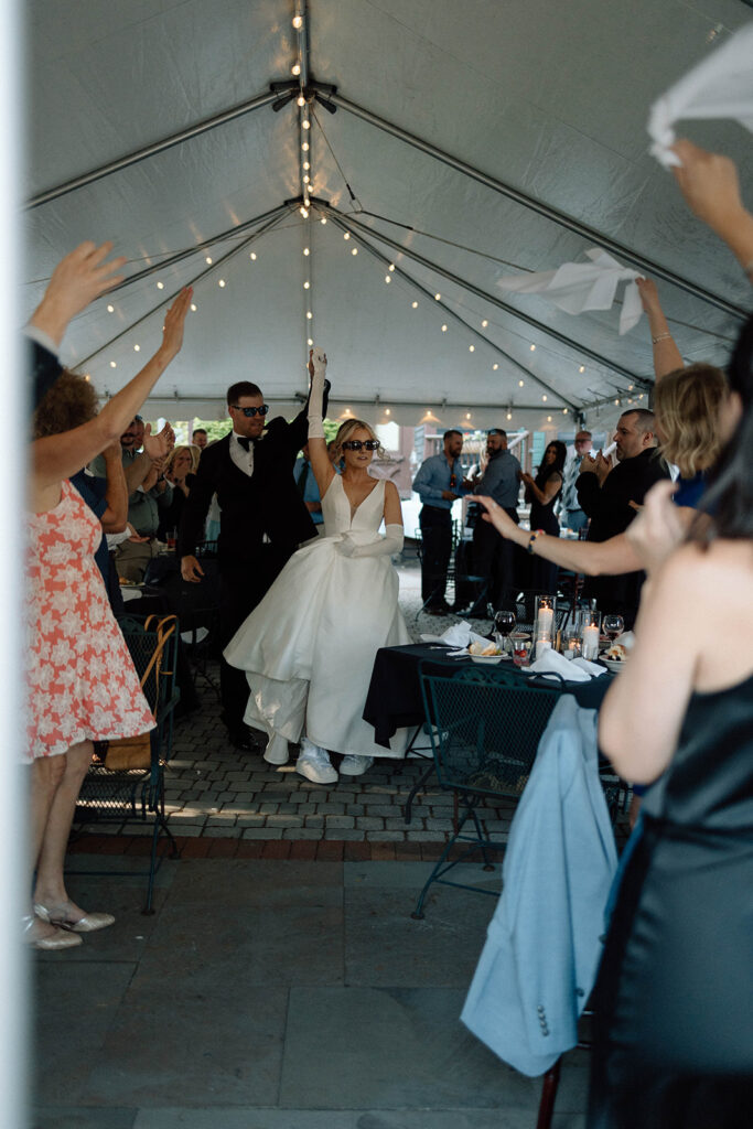 Bride and groom entering their reception and following their wedding photography timeline.