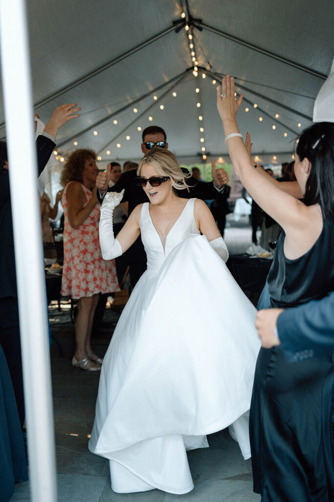 Bride dancing wearing glasses.