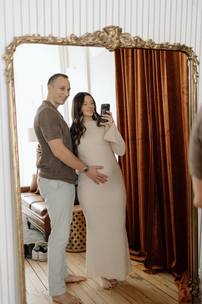 The soon-to-be parents taking a mirror selfie.