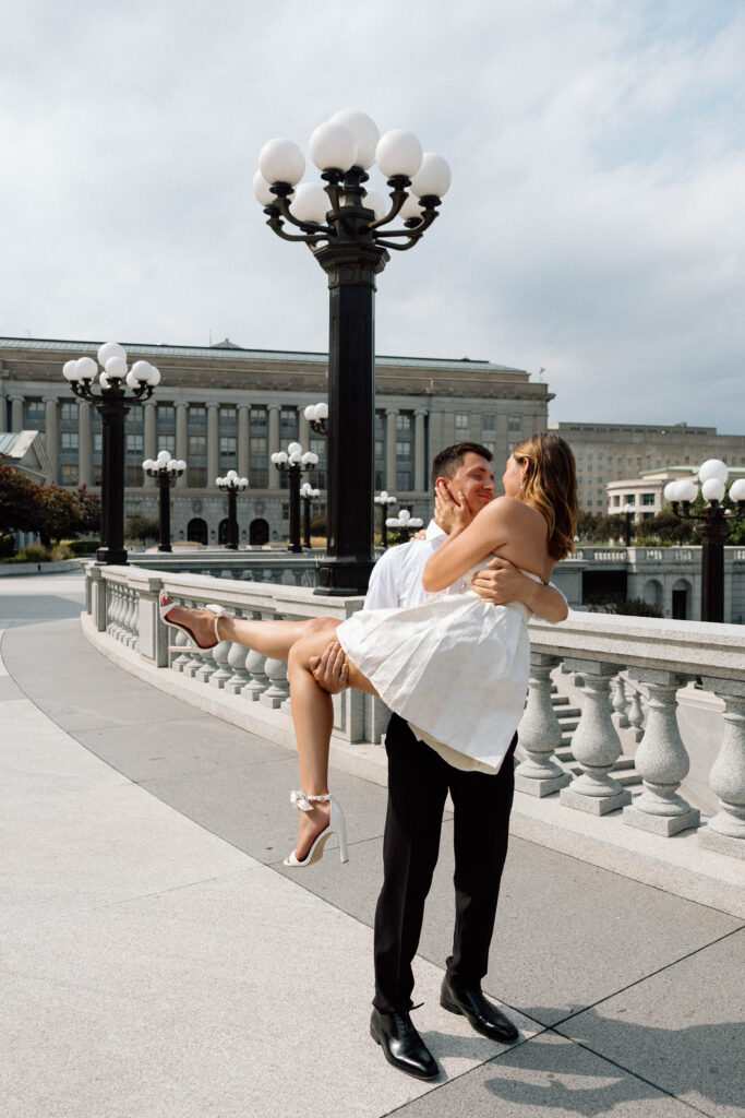 Engagement photo poses of a guy spinning his fiance. 