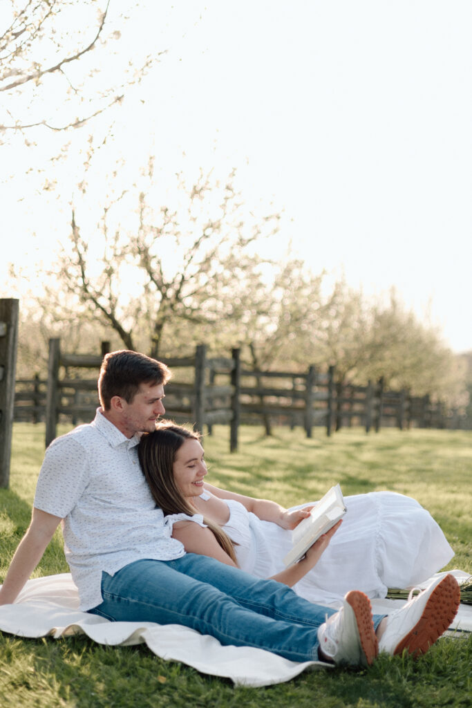 Engagement photo poses of a couple reading the Bible together.