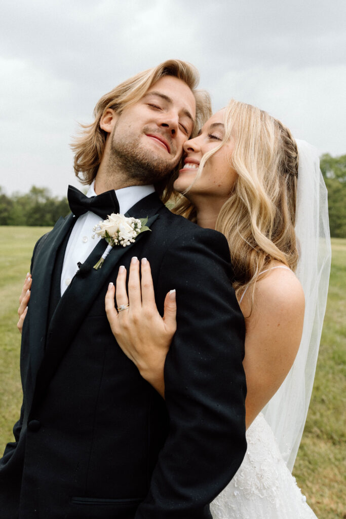 Editorial wedding photography of a bride and groom hugging with pure smiles on their face after getting married.