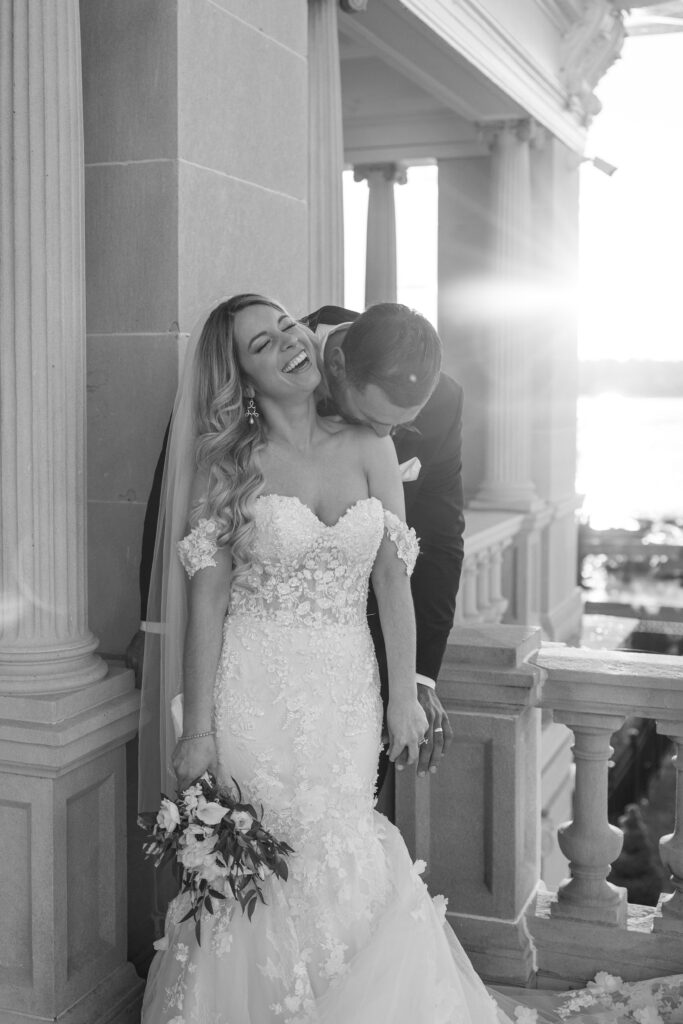 Groom kissing his wife's neck.