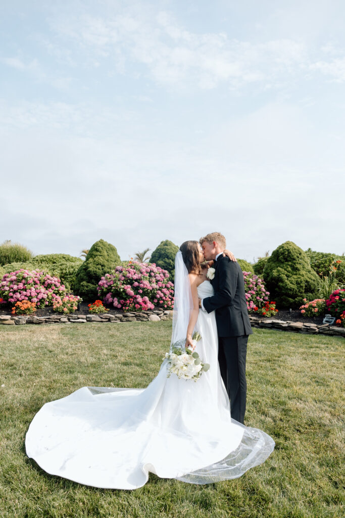 Bride and groom kissing after their luxury wedding.