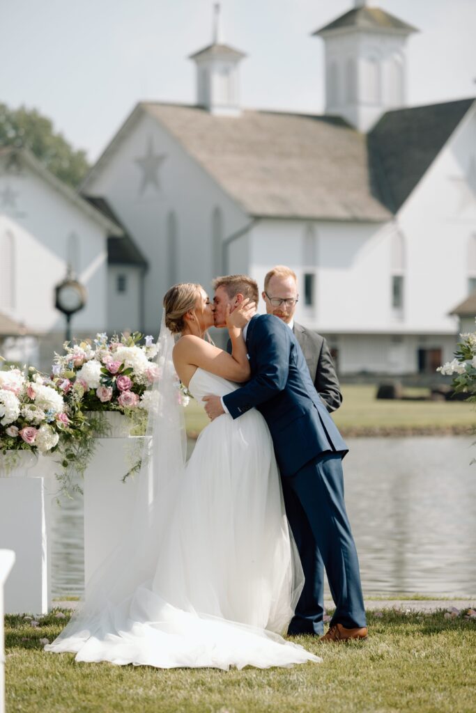 Bride and groom kissing for wedding photography tips for photographers.