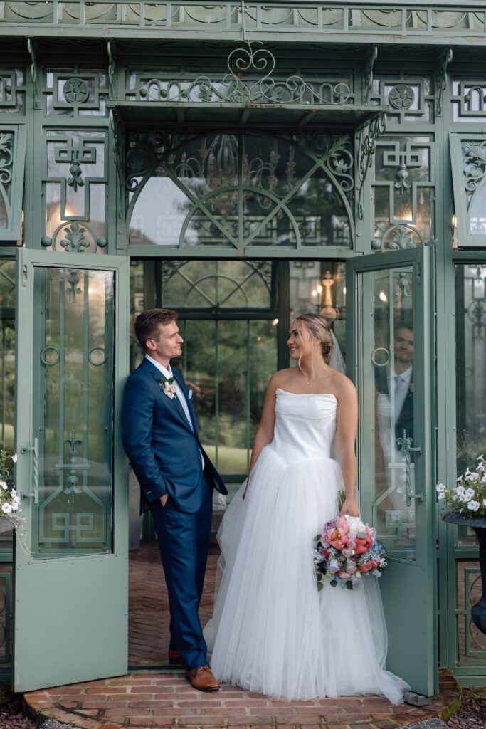 Bride and groom looking at one another romantically. 