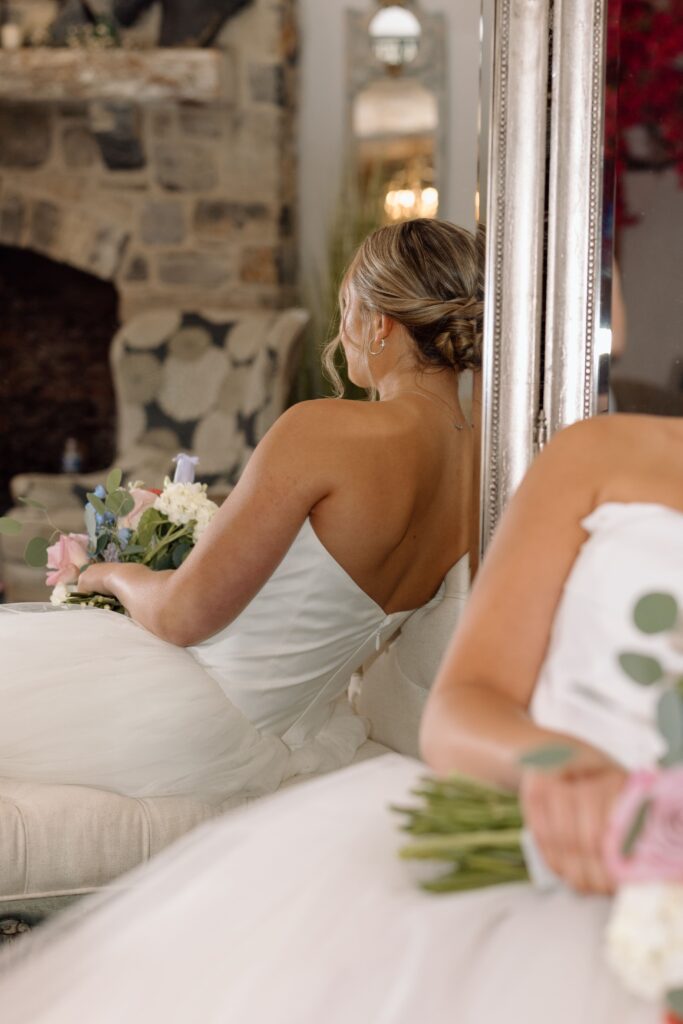 Detail shot of the bride's hair and florals through a mirror. 