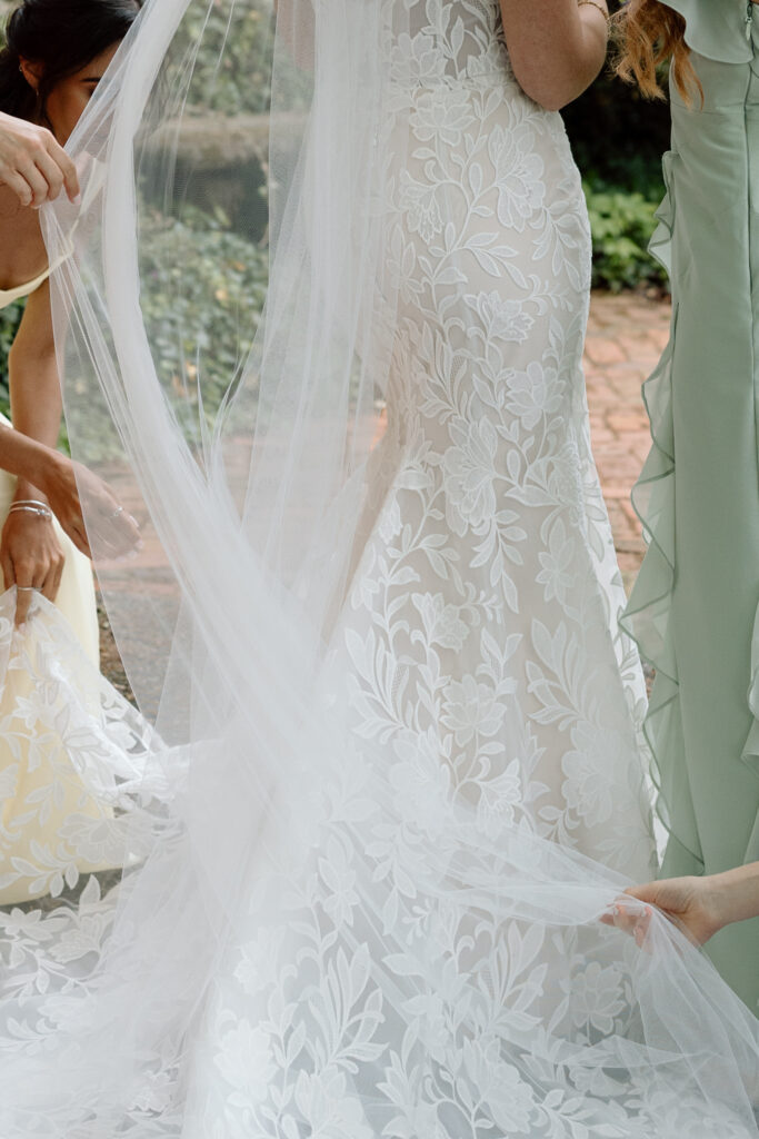 Close up of bride's wedding dress and veil for an idea of how to pick a wedding photographer.