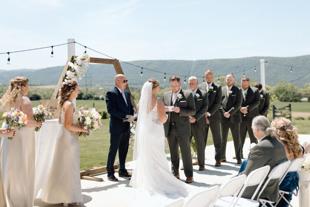 Bride and groom reading vows during their ceremony at one of the best Pennsylvania wedding venues, The Goldfish Barn Event Center. 