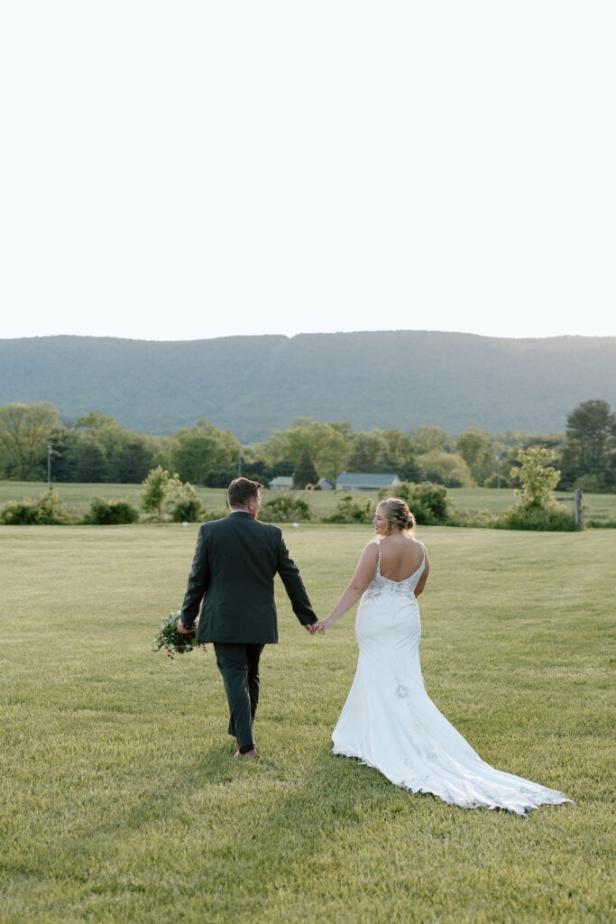 Newlyweds walking off into sunset.