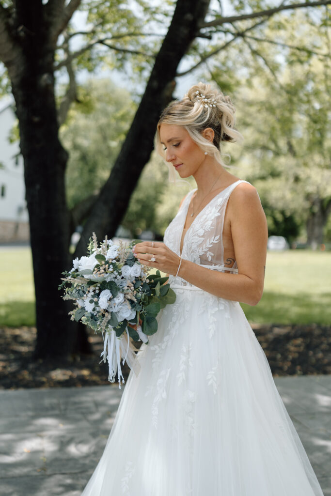 Bride looking at her bouquet.