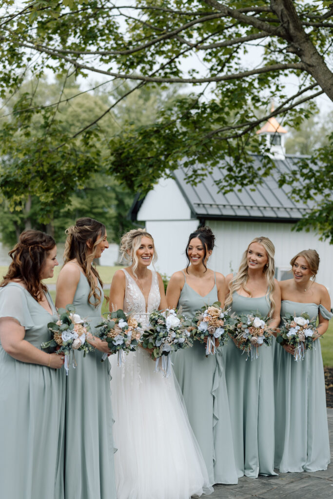 Bride and bridesmaids smiling together. 