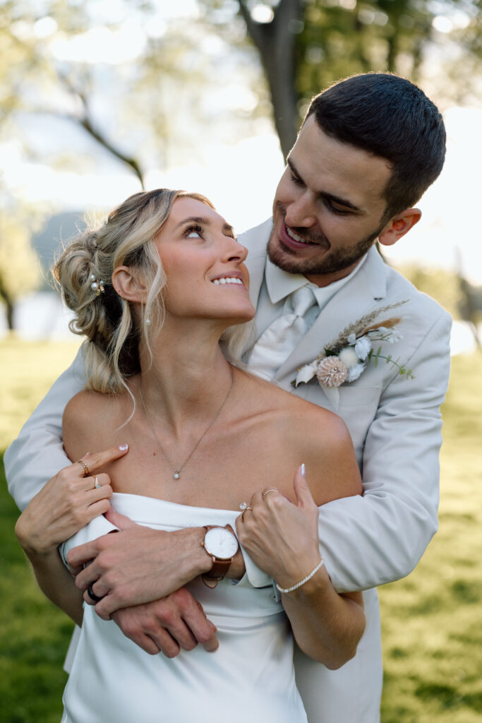 Newlyweds smiling at one another at the River Bend Venue in Pennsylvania. 