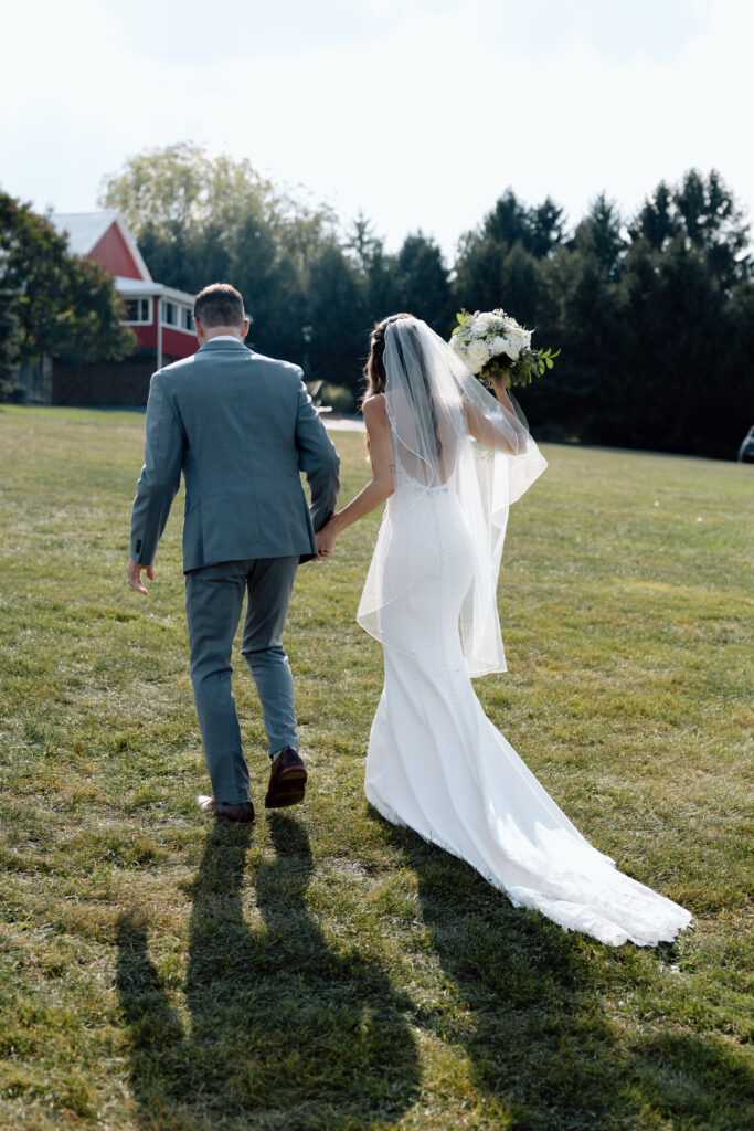 Bride and groom walking away from their ceremony at Wind in the Willows, one of the best Pennsylvania wedding venues.