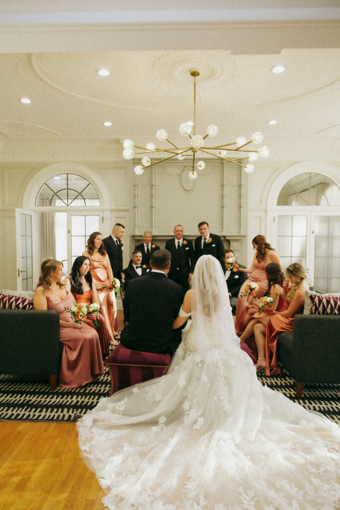 Bridal party sitting around talking at King Mansion, a PA wedding venue.