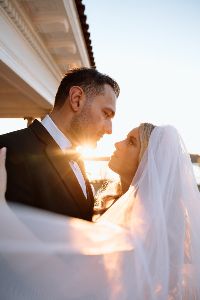 Newlyweds looking into each others eyes during sunset. 