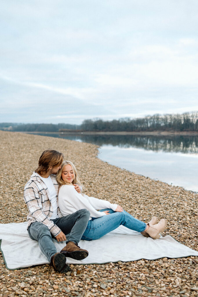 Couple sitting on a blanket by a lake at Cordorus State Park in PA.
