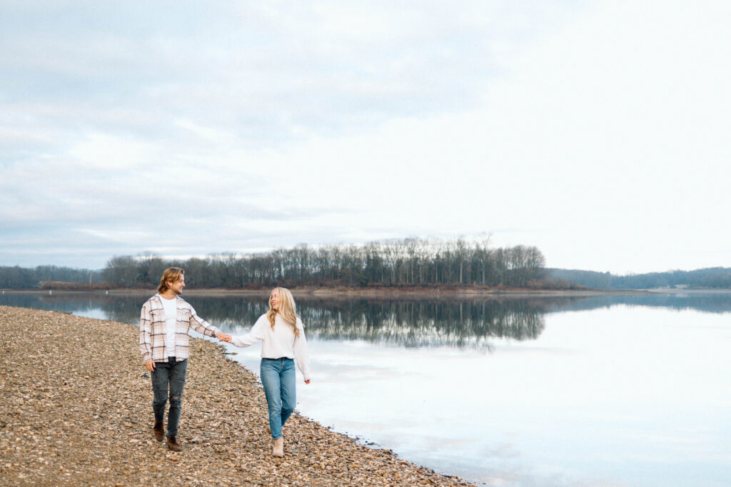 Couple walking hand in hand around a lake at Cordorus State Park.