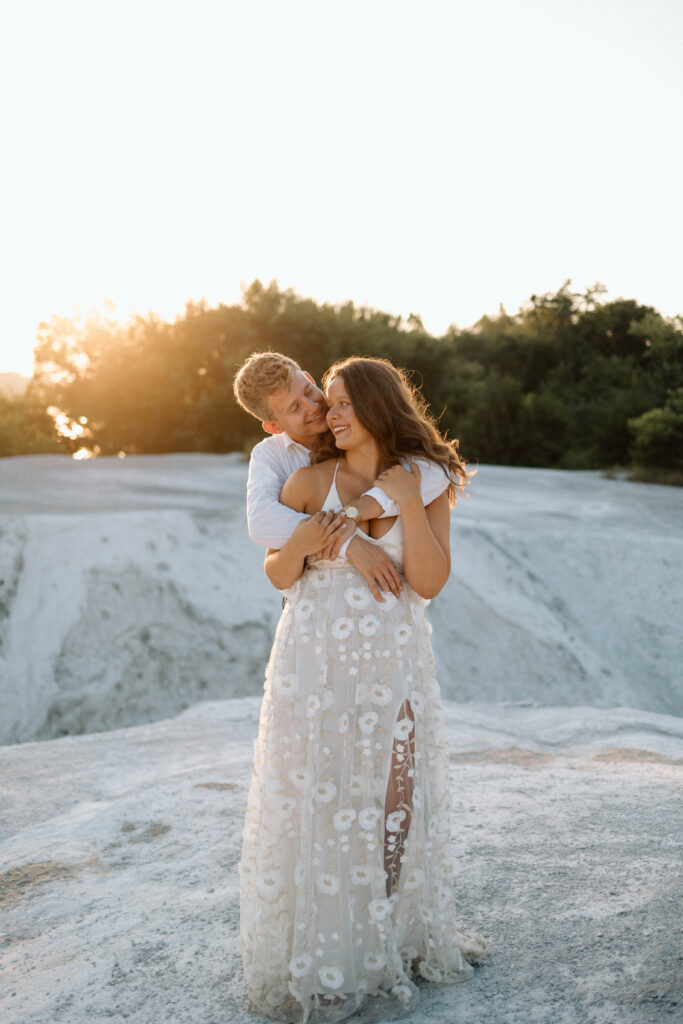 Engaged couple showing what to wear for engagement pictures during golden hour.