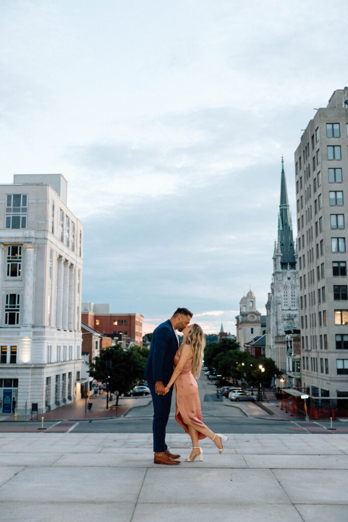An engaged couple sharing what to wear for engagement pictures for a classy look in downtown PA.