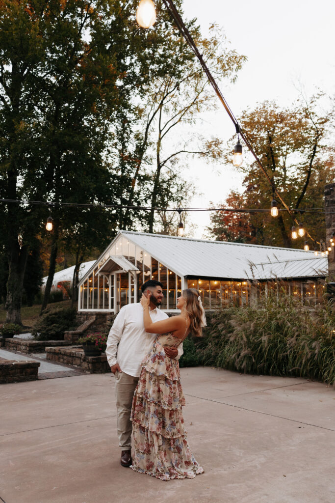 A couple looking at one another romantically white showing what to wear for engagement pictures.