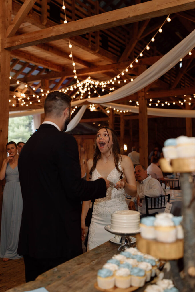 Bride with a big smile on her face before eating dessert. 